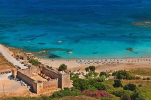 an aerial view of a beach with a castle and the ocean at Villa Elia in Sfakia