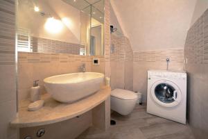 a bathroom with a sink and a washing machine at Tramonti di Sole in Tramonti +71 photos