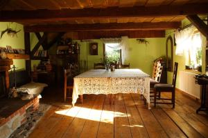 a dining room with a table in the middle of a room at Ustronne siedlisko in Sorkwity