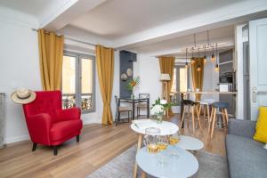 a living room with a red chair and a red couch at Appart' Vieil Antibes in Antibes