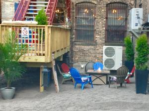 a deck with chairs and a table in front of a building at Hostel du Nord in Duluth