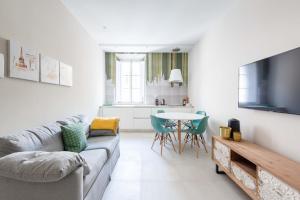 a living room with a couch and a table at SuityRHome RioneMonti54 in Rome