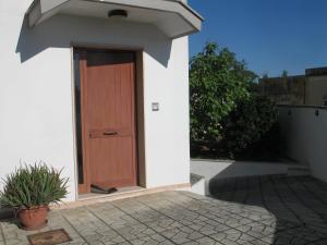 a wooden door on the side of a house at Salentino in Lequile