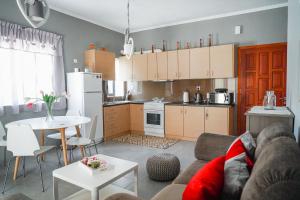 a kitchen and living room with a couch and a table at Georgia's House in Galatas