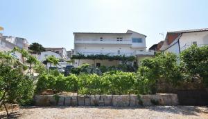 a view of a house with a garden in front of it at Apartments and Room Mate-Mare in Primošten +16 photos