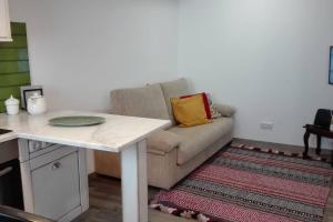 a living room with a couch and a table at Azoka by the Sea- Centro Histórico de Peniche in Peniche