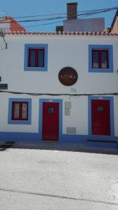 a blue and white building with red doors at Azoka by the Sea- Centro Histórico de Peniche in Peniche
