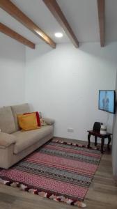 a living room with a couch and a rug at Azoka by the Sea- Centro Histórico de Peniche in Peniche