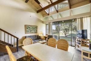 a living room with a table and chairs at Alea Condo in Kahuku