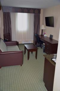 a living room filled with furniture and a tv at Coast Lethbridge Hotel & Conference Centre in Lethbridge
