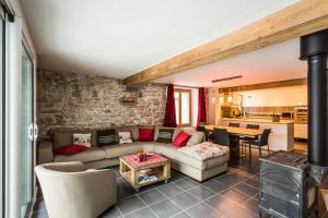 a living room with a couch and a table at Les Iles 1776 in Chamonix-Mont-Blanc