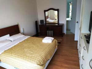 a bedroom with a bed with a dresser and a mirror at Beautiful Apartment Financial Zone-Fully Furnished in Lima