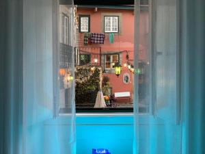 a view of a swimming pool through a window at The Spot in Alfama in Lisbon