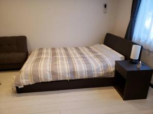 Ένα ή περισσότερα κρεβάτια σε δωμάτιο στο Furano Mount Villa