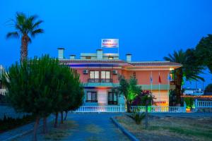a building with a sign on the top of it at Kabasakal Otel in Çeşme