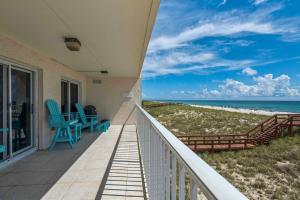 a balcony with chairs and a view of the beach at Sea Oats Condo Unit #202 in Navarre +35 photos