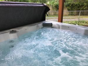 a hot tub with water in the back of it at Ed & Rosie's Place in Black Mountain