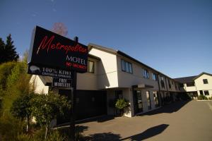 una señal de motel frente a un edificio en Metropolitan Motel on Riccarton, en Christchurch