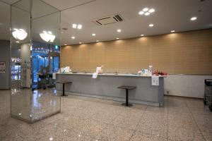 a lobby with a counter in a building with at Kesennuma Plaza Hotel in Kesennuma +17 photos