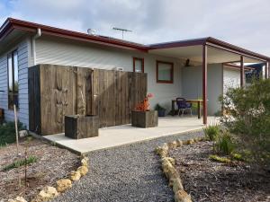 a home with a wooden fence and a patio at Samphire: Coorong Accommodation in Meningie