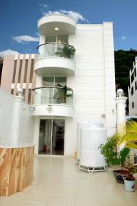 a white building with a balcony on the side of it at Homestay coco in Vung Tau
