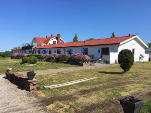 a white house with a red roof at Solö in Byxelkrok