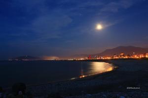 a view of a beach at night with the moon at 500Km Home in Hualien City