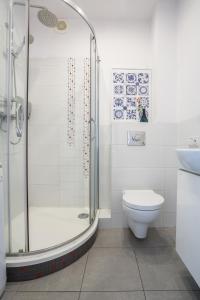 a bathroom with a shower and a toilet and a sink at ★Bright, spacious apartment|Palace of Culture view★ in Warsaw