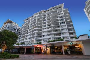 a large building with a clock on the front of it at Seamark on First in Mooloolaba