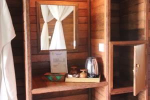 a shelf in a wooden cabin with a mirror at Dream Beach Inn in Nusa Lembongan +47 photos