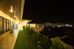 a night time view of a building with a lawn at The Lanang Suites in Davao City