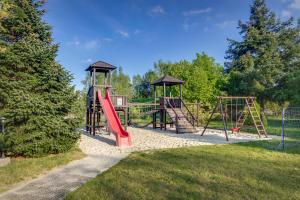 a playground with two swings and a slide at Ferien Hotel Spreewald in Kolkwitz
