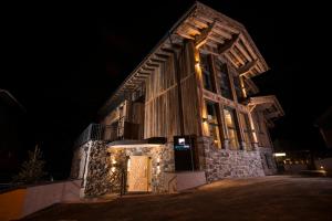 a building with lights on the side of it at night at Gletscherblick- serviced apartments in Obergurgl