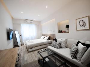 - un salon avec un canapé et un lit dans l'établissement Downtown Syntagma apartment 2, à Athènes