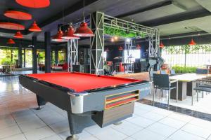 a pool table in the middle of a room at Labuana Homestay & Cafe Garden in Makassar