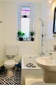 a white bathroom with a toilet and a sink at Apartament Górski 90m2 blisko centrum i wyciagu in Szklarska Poręba