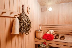 a room with a sauna with a bench with a red blanket at Отель Грейс Олимпия in Krasnaya Polyana