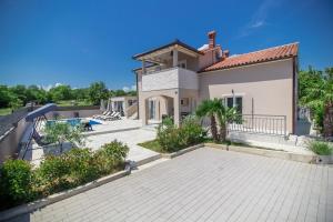 a house with a patio and a swimming pool at Villa Franka in Labin