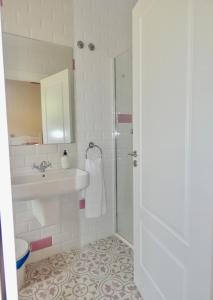 a white bathroom with a sink and a shower at Hotel Casa Sueño in Salas +42 photos