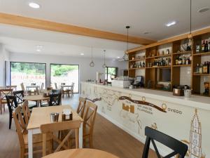 a restaurant with tables and chairs and a counter at Hotel Casa Sueño in Salas