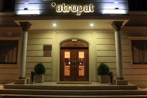 an entrance to an apartment building with a sign above the door at Atropat Old City Hotel in Baku