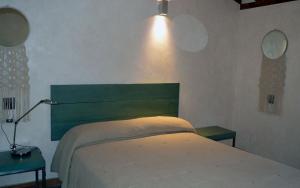 a bedroom with a bed and two tables and a lamp at Santa Brigida - Real 1 in Hontanas