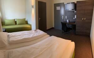 Voodi või voodid majutusasutuse Behringers City Hotel Nürnberg toas