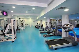 a gym with a row of treadms and machines at Nestor Hotel in Ayia Napa