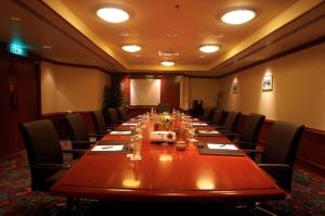 a conference room with a long wooden table and chairs at The Magellan Sutera Resort in Kota Kinabalu +62 photos