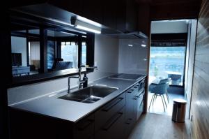a kitchen with a sink and a counter with a window at Okune in Goto