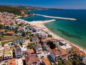 an aerial view of a beach with buildings and the ocean at Estian Deluxe in Limenaria