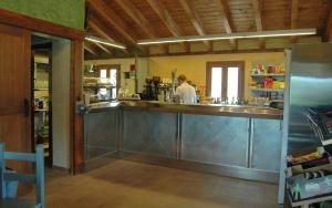 a bar in a restaurant with a man in a kitchen at Santa Brigida - Real 1 in Hontanas