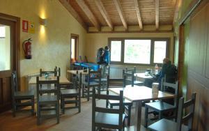 a restaurant with tables and chairs and people sitting at them at Santa Brigida - Real 1 in Hontanas