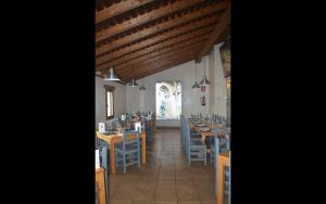 a dining room with tables and chairs and a window at Santa Brigida - Real 1 in Hontanas